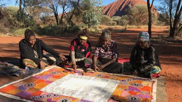 Artists complete their work on the Uluru Statement of the Heart in 2017. 