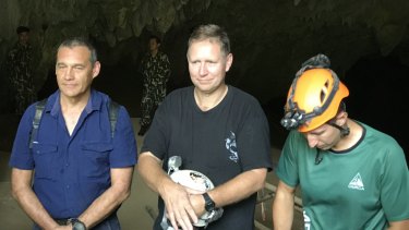 Triumphant return: Craig Challen, Richard Harris and American Joshua David Morris at the entrance to Tham Luang Cave in Thailand on Monday.