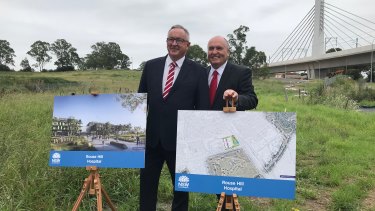 Liberal MPs Brad Hazzard and David Elliott stand on the newly acquired land where the Rouse Hill Hospital will be built.