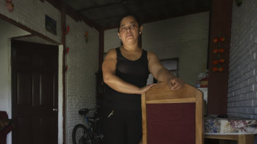 Rosa Ramirez poses for a photo at her home in San Martin, El Salvador.