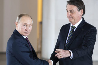 Brazilian President Jair Bolsonaro, right, welcomes Russian President Vladimir Putin to a meeting of leaders of the BRICS countries in Brasilia in 2019.