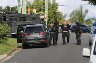 Police seized a range of items in their search of two properties on Wednesday, including weapons, drugs and cash. 