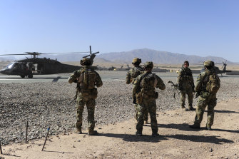 SAS soldiers on duty in Afghanistan move towards a waiting UH-60 Blackhawk helicopter.