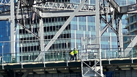Workers on the Story Bridge footpath on Wednesday.