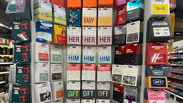 The Card Network cards (centre) are available to buy at major retailers including Woolworths and Coles.