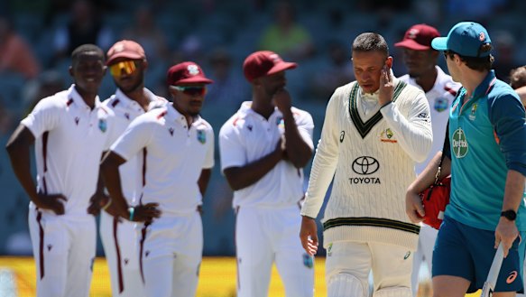 Usman Khawaja leaves the field after being hit on the jaw by a bouncer in Adelaide on Friday.