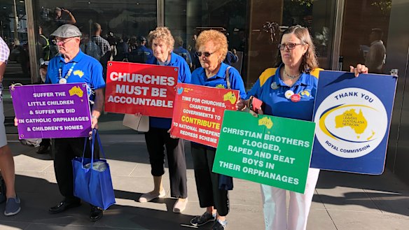 Protesters standing outside Melbourne County Court ahead of George Pell's arrival.  