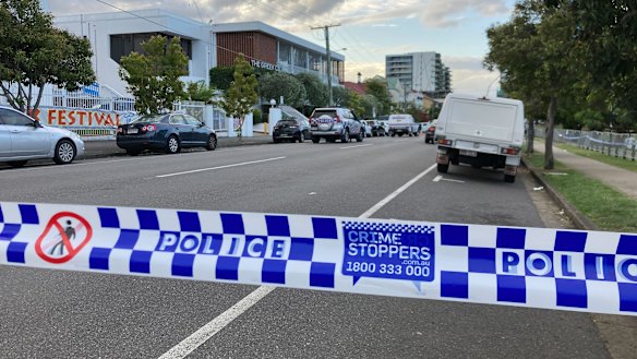 Police closed off the street after the shooting outside the Greek Club, where signs are advertising a Greek festival within days.