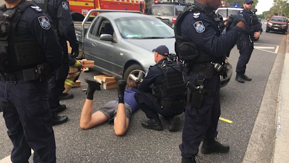 The protester locked to a car outside an International Women’s Day breakfast hosted by the Queensland Resources Council.
