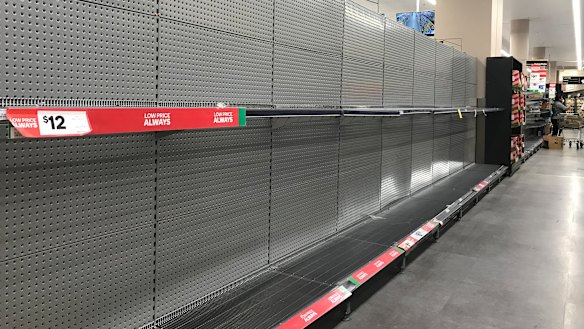 Empty shelves in the toilet paper aisle at Woolworths in Bondi Junction, NSW.
 