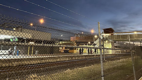 Police conduct wanding searches at Goodna Railway Station.