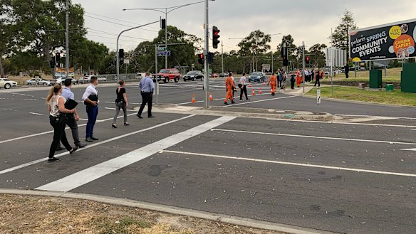 Police and SES do a line search from a Bundoora tram stop to where a woman's body was found on Wednesday morning.