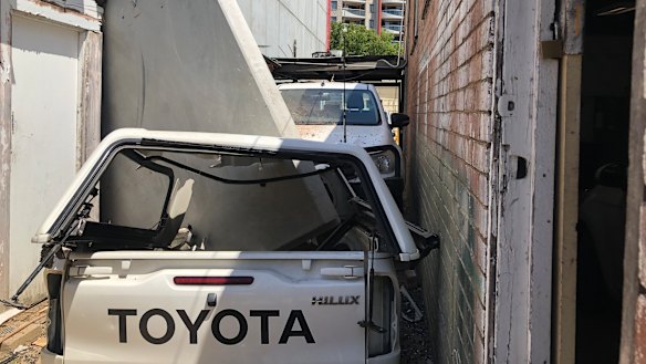 The concrete panel also appears to have crushed a car.