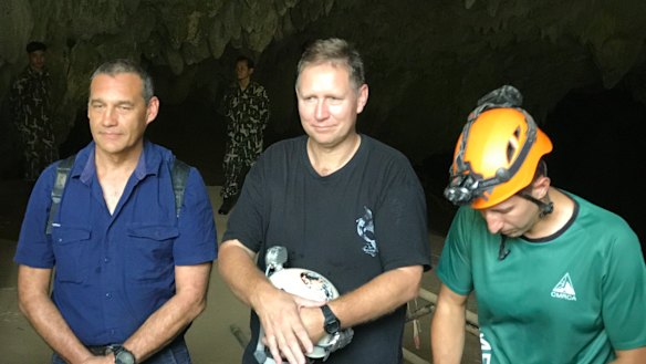 Triumphant return: Craig Challen, Richard Harris and American Joshua David Morris at the entrance to Tham Luang Cave in Thailand in April.