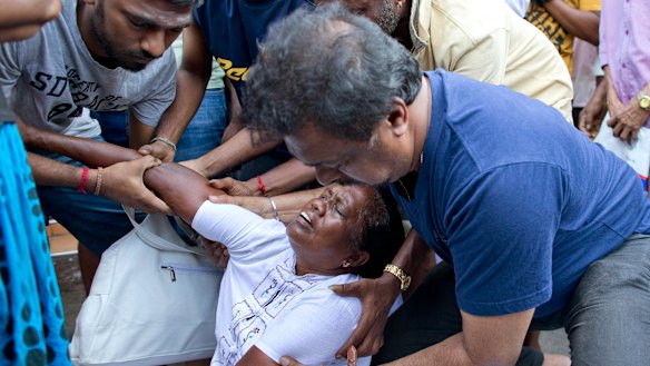 People help a woman who fainted as she was praying. 