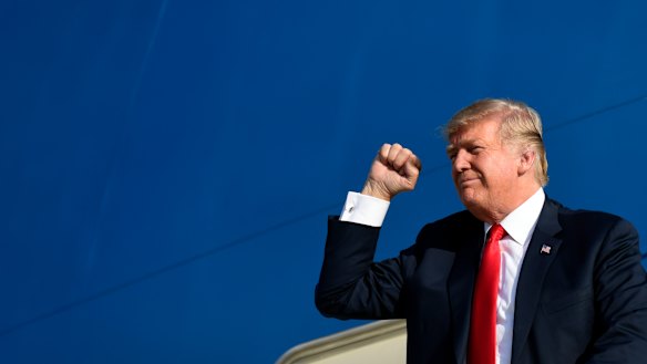 Donald Trump gestures as he walks down the steps off Air Force One on Monday.