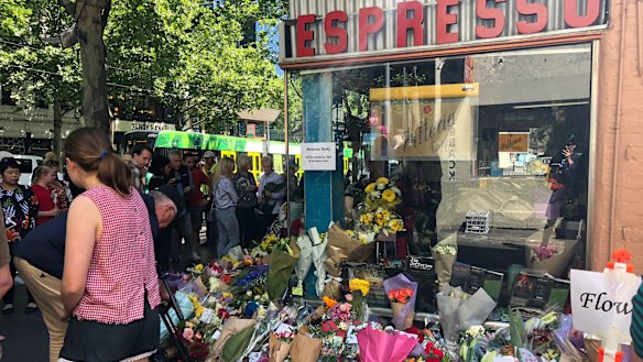 Flowers left outside Pellegrini's in Bourke Street in memory of attack victim Sisto Malaspina.