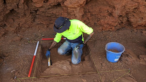 Eastern Guruma traditional owner Kelvin Hughes undertaking excavation within one of the rock shelters. 