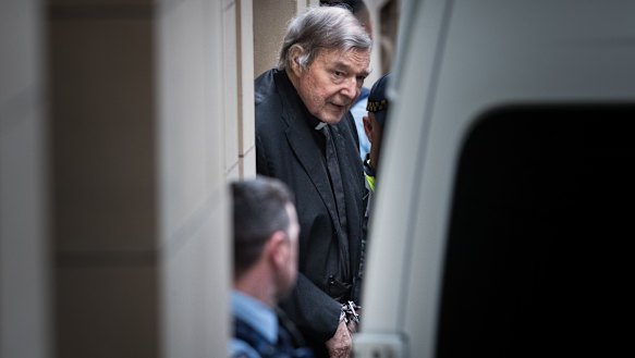 Paedophile George Pell leaves Melbourne's Supreme Court building in handcuffs on Wednesday.