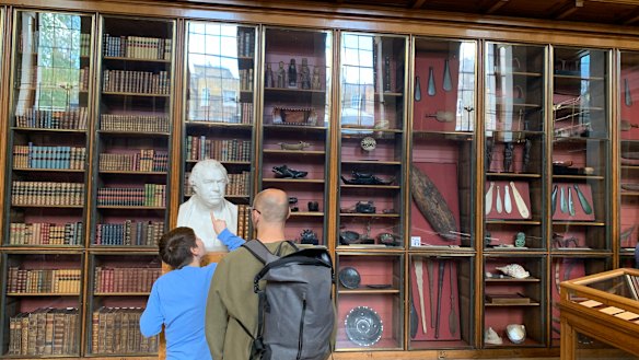 A boy examines a bust of Joseph Banks at the British Museum.