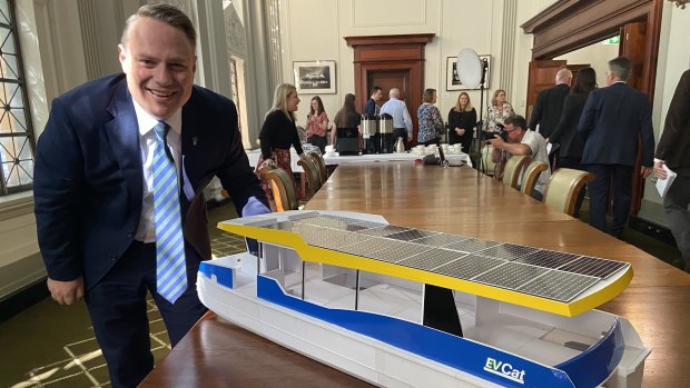 Brisbane Lord Mayor Adrian Schrinner with a model of an EVCat, which would be smaller than a CityCat but larger than a KittyCat.