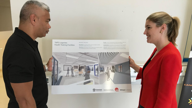 Queensland Training Minister Shannon Fentiman examines concept drawings of new nurse training wards at Loganlea TAFE campus with Rork Projects John Paul Janke.