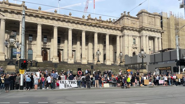 Demonstrators gather at the steps of Parliament House on Tuesday evening.