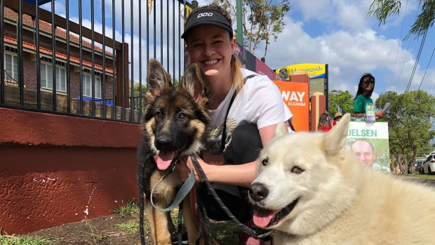 Jacqueline, a teacher at Morningside State School, votes with her dogs Honey and Boo.
