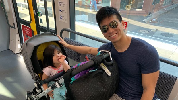 Josh Koh and daughter Arabelle ride the tram from Randwick to the city on Monday morning. 