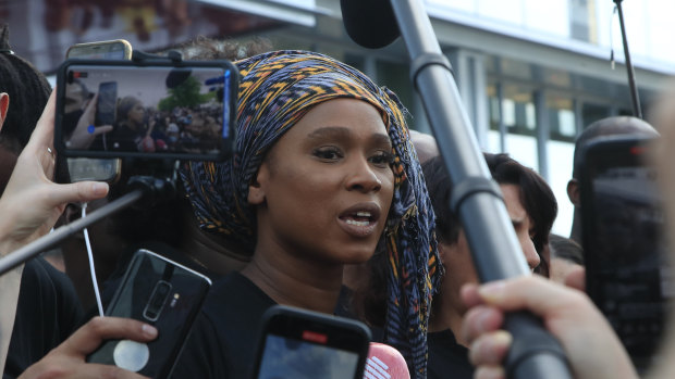 Assa Traore, sister of Adama Traore, answers reporters outside the Palace of Justice in Paris.