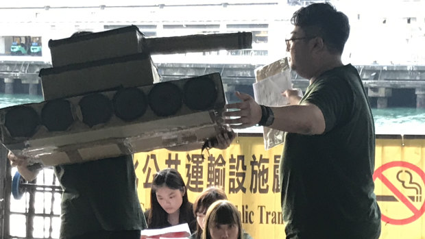 University students in Hong Kong re-enact the Tiananmen Square crackdown for evening ferry commuters. 