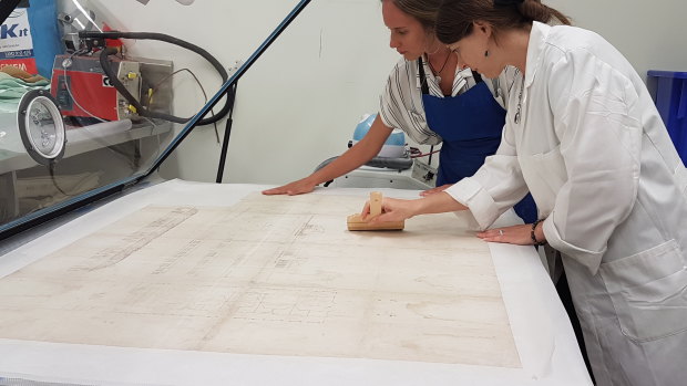 Conservators hard at work in the State Library of Queensland.
