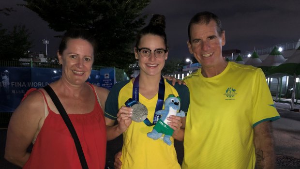 Kaylee McKeown with her late father Sholto, mum Sharon and her silver medal from the 2019 world championships.