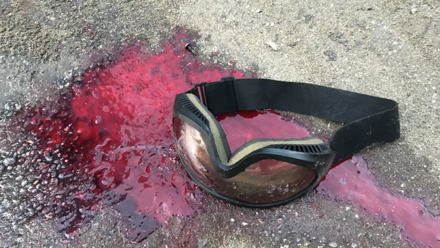 Blood and goggles left on road after police moved in at Hong Kong Polytechnic University. 