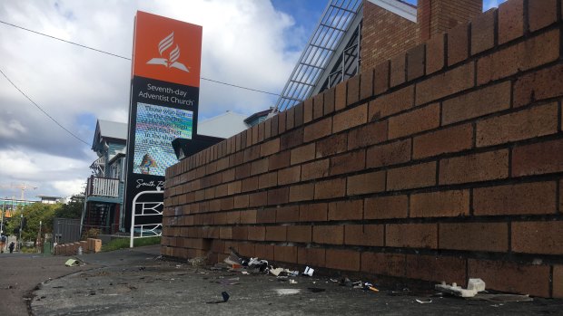 The car collided with this brick wall outside the Woolloongabba church.