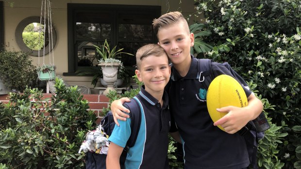 Brothers Noah Newstead, 7, and Jacob Newstead, 10, are excited to throw aside their masks. 