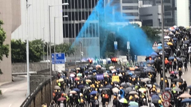 Police fire blue dye at protesters designed to identify them after they leave a scene.