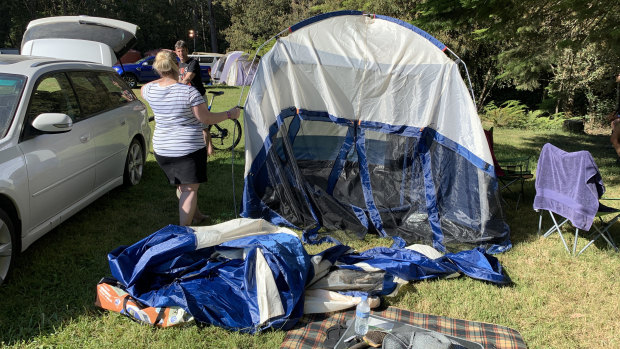 Festival goers pack up their tents on Sunday after the Falls Festival in Lorne was cancelled.