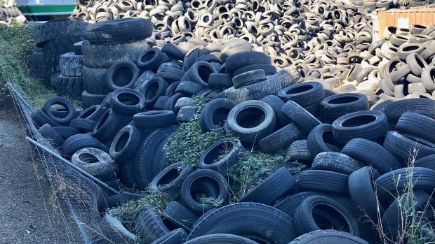 Tyres stored at Tyremil have collapsed the fence with the neighbouring transport business.