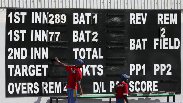 Ground staff set the scoreboard after England's dismal first innings.