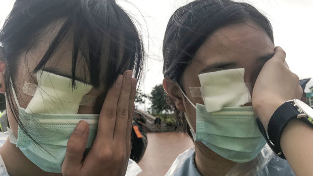 Ezoe and Brittany, 15, at a student strike in Hong Kong, wear eye patches to remember a woman who was hit in the eye by what was believed to be a police bean bag round. They say they are protesting because they "love Hong Kong".