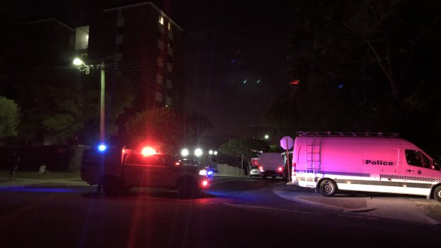 Forensics and an ambulance at the crime scene. 