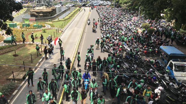 Gojek, Uber and Grab drivers shut down part of Jakarta on Tuesday to demand equal pay.