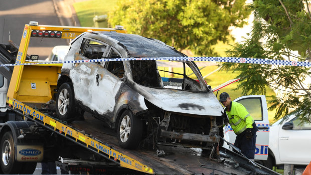 The burnt-out car is taken away from Raven Street in Camp Hill on Wednesday.