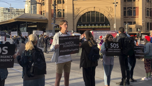 Protesters in the middle of the Flinders and Swanston streets intersection.