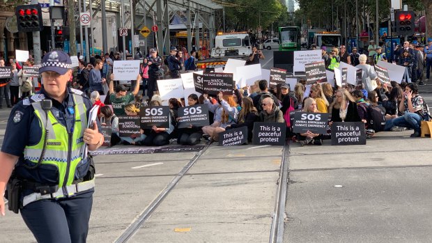 Vegan protesters block one of Melbourne's busiest intersections.