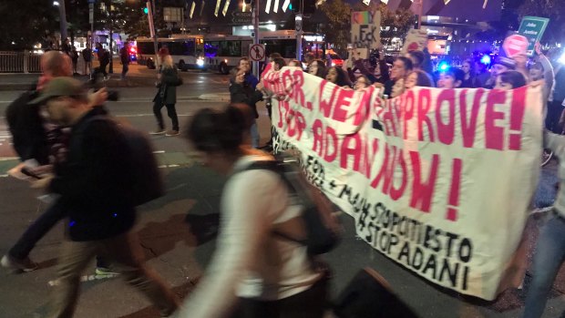 Anti-Adani protesters cross the Victoria Bridge in Brisbane on Friday, June 21, 2019.