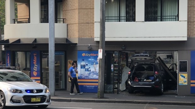 The black SUV was wedged in the front of the convenience store.