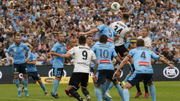 Head for heights: Connor Metcalfe nods home a goal to put Melbourne City 1-0 up.