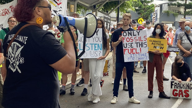 Activists call for the scaling back of fossil fuels outside the Australian Petroleum Production and Explorers Association conference in Brisbane on Tuesday.